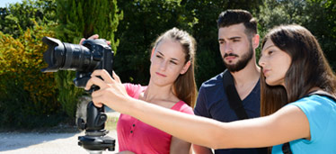 3 people working a camera
